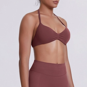 Side view of dark burgundy seamless high-waist yoga set with halter neck sports bra