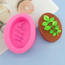 Pink oval silicone mold for handmade soap featuring an embossed leaf design with brown finished soap