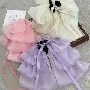 Elegant chiffon bow hair claw clips in beige, pink and purple for voluminous hair styling