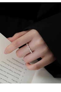 Close-up of minimalist S925 sterling silver beaded ring on a woman's finger