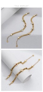 Detail view of gold chain bracelet with multicolor stones and Roman numeral engraving