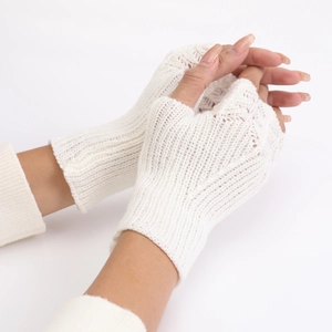 Detail of white fingerless knit gloves showing delicate fish scale texture and soft wool