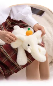 Gros plan sur un éléphant en peluche blanc avec décoration d'orange en cadre cosy