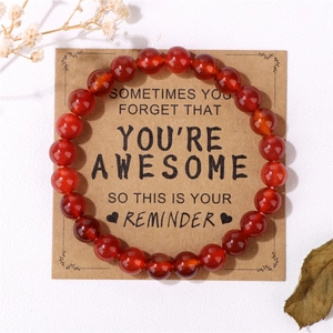 8mm red natural stone bead bracelet displayed on a motivational kraft paper card