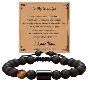 Detailed view of beaded bracelet with To My Grandpa message card on kraft paper