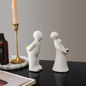 Modern white ceramic couple figurines with silver heart and colorful flower bouquet