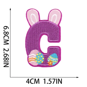 Detailed embroidery patch of purple letter C with rabbit ears and Easter egg motif