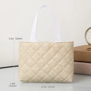 Close-up of beige quilted tote bag with metric dimensions and lifestyle props