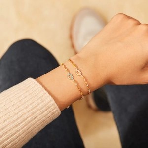 Minimalist S925 silver knot enamel bracelets in gold finish worn on a wrist