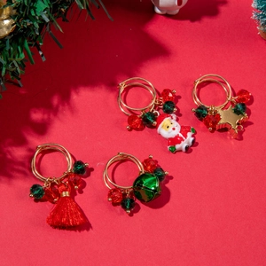 Close-up of a 4-piece Christmas wine glass ring set with festive charms and tassels