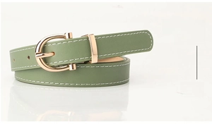 Detail of green PU leather belt with white stitching and golden D-ring buckle