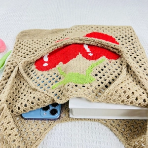 Detail of hollow knit tote bag featuring red cherry embroidery and large capacity
