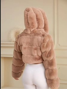 Detailed back view of short faux fur jacket in light brown with hood and plush texture