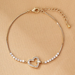 Detail of gold heart pendant bracelet with micro-pave zircons and venetian chain