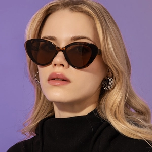 Close-up of stylish tortoiseshell cat eye sunglasses for women with dark brown lenses