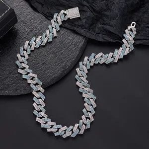Macro shot of silver Cuban link chain with luxury blue and white pavé setting