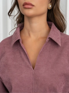 Detail of rose pink corduroy texture with lapel collar and golden pearl earring