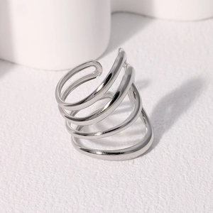 Detail of multi-layer spiral silver ring showing polished metal texture and open design