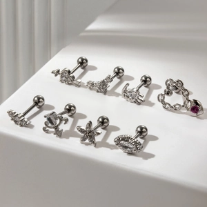 Set of 8 silver stainless steel stud earrings with heart, flower, and star motifs