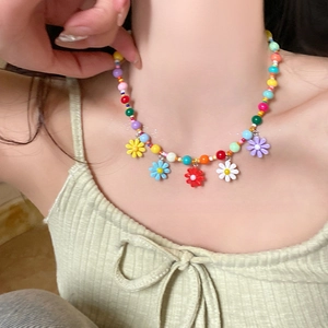 Colorful beaded daisy necklace featuring multi-color round beads and flower charms