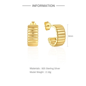 Detail of 925 sterling silver C-shape earrings with gold finish and rippled texture