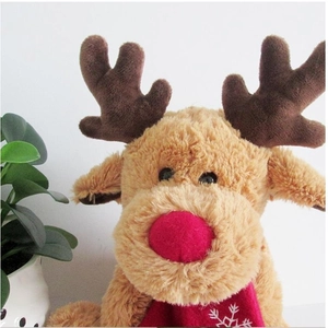 Close-up of plush reindeer with a red nose and snowflake pattern scarf detail