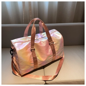 Close-up of pink gradient travel bag with metallic finish on a soft beige sofa