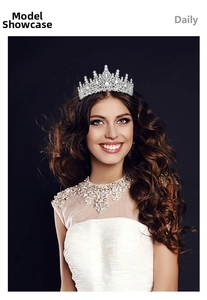 Close-up of a silver rhinestone bridal crown featuring sparkling pointed spires on a model
