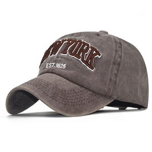 Detailed close-up of brown 3D embroidered NEW YORK EST. 1625 text on washed cotton cap