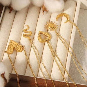Detailed display of gold titanium steel necklaces with sun, moon and heart pendants