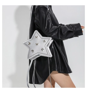 Detail of silver star-shaped shoulder bag with butterfly studs and metal chain strap