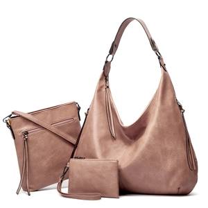 Detailed close-up of a three-piece pink faux leather tote bag set with tassel accents