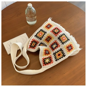 Detailed knit shoulder bag with colorful crochet geometric squares and boho tassels