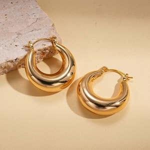 Minimalist 18k gold plated chunky teardrop earrings displayed on natural stones