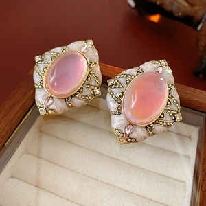 Macro shot of vintage style gold earrings with pink stones and crystals in jewelry box