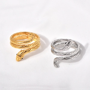Detail of snake scale texture and black eyes on gold and silver stainless steel rings
