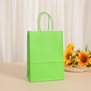 Close-up of bright green kraft paper gift bag with twisted rope handle and sunflower décor