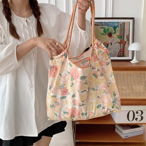 Floral drawstring canvas tote bag styled in a cozy home setting for large capacity use