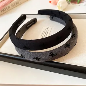 Elegant wide headband set in black and grey with textured fabric and bow patterns
