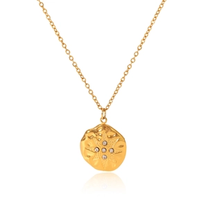 Detail of 18K gold stainless steel hammered pendant with diamond-set star pattern