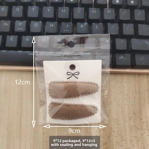 Close-up of brown faux cashmere teardrop BB clips in clear packaging with 9x12cm size label