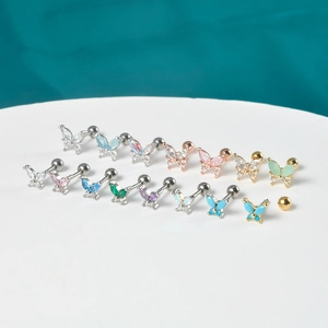 Macro detail of butterfly stud earrings featuring colorful zircons and ball screw backs