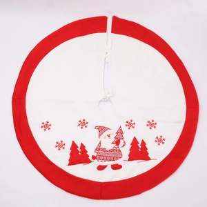 Detail of red Christmas tree skirt with Santa and snowflake embroidery and white border
