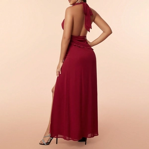 Detail of elegant backless halter neck and high slit on burgundy chiffon maxi dress