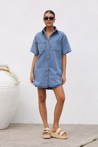 Detail of short-sleeved denim shirt dress with double chest pockets and button closure