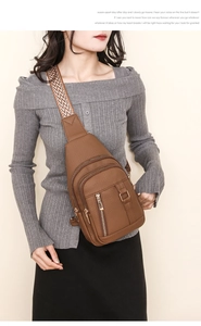 Brown PU leather chest bag with lychee texture and colorful woven shoulder strap details