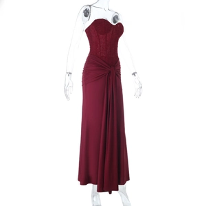 Detail showing the burgundy evening dress with lace bodice and gathered waist knot
