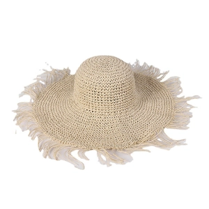 Women's handmade crochet straw sun hat with frayed fringe edges in beige color