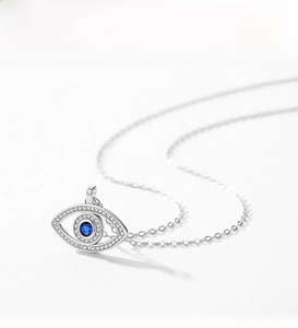 Macro detail of S925 sterling silver evil eye pendant with blue and white zircon