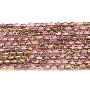 Macro shot of 6x8mm faceted purple glass beads with golden electroplated finish for DIY